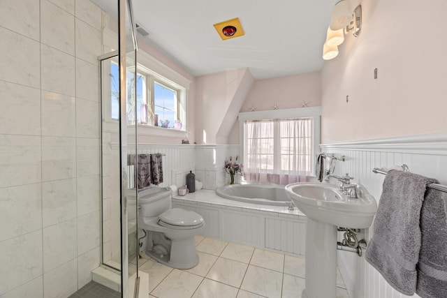 bathroom with independent shower and bath, toilet, plenty of natural light, and tile patterned flooring