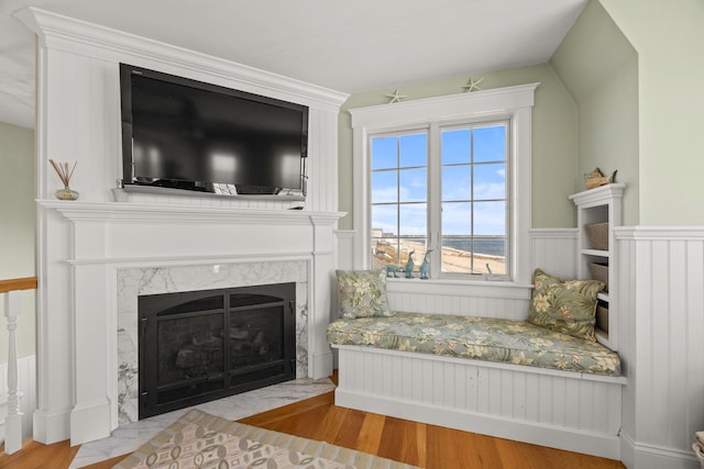 sitting room featuring light hardwood / wood-style floors and a high end fireplace