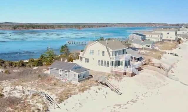 aerial view with a water view and a beach view