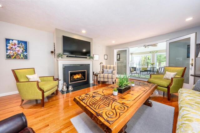 19 Longwood Rd, Mashpee, MA 02649 - living area featuring wood finished floors, recessed lighting, a fireplace with flush hearth, baseboards, and ceiling fan