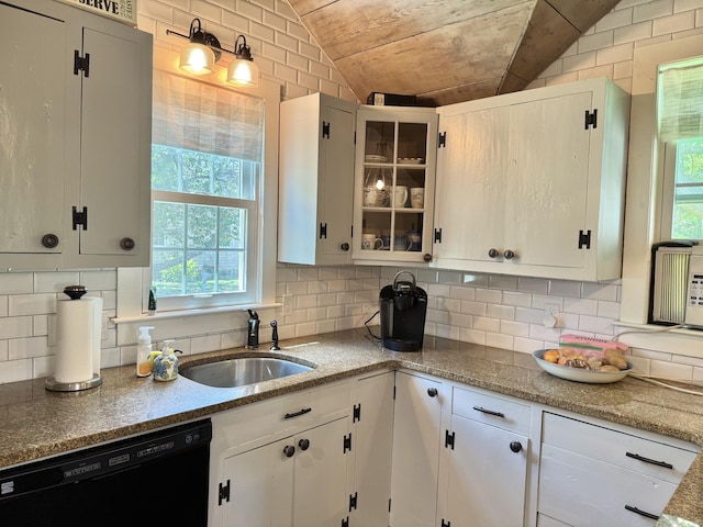 11 Willow Ln, South Yarmouth, MA 02664 - kitchen with black dishwasher, glass insert cabinets, backsplash, white cabinetry, and lofted ceiling