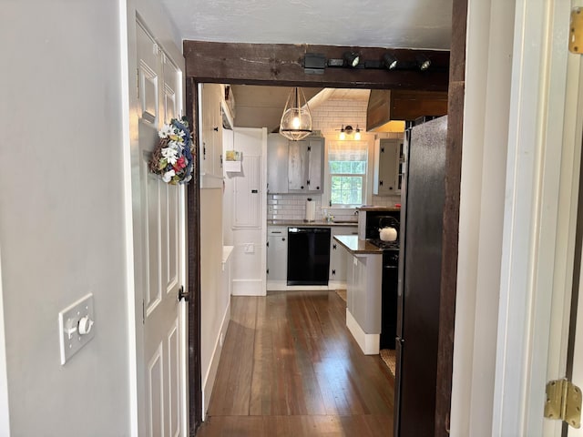 11 Willow Ln, South Yarmouth, MA 02664 - kitchen featuring dishwasher, dark wood-style flooring, beam ceiling, backsplash, and freestanding refrigerator