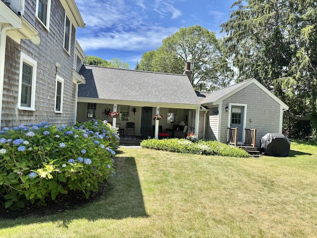 11 Willow Ln, South Yarmouth, MA 02664 - rear view of property with a lawn, covered porch, a chimney, and roof with shingles