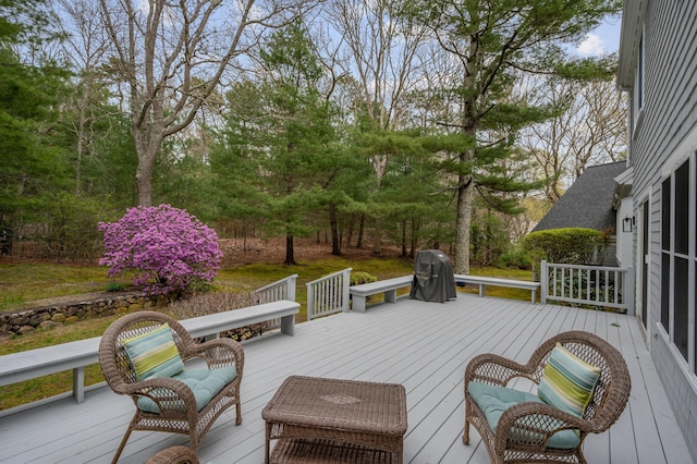 wooden deck with a grill