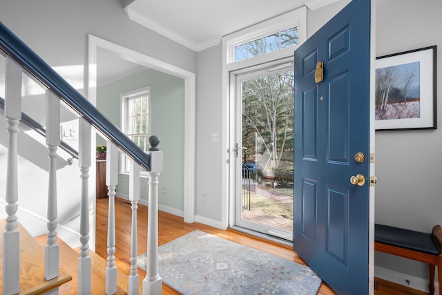 entrance foyer with crown molding and hardwood / wood-style floors