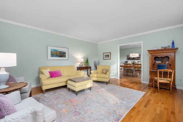 living room featuring wood-type flooring and ornamental molding