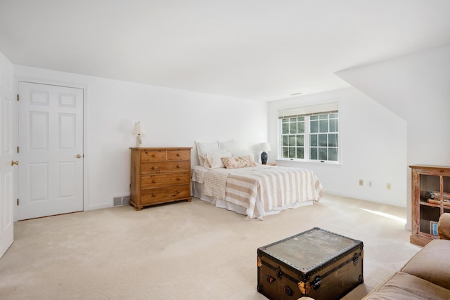 bedroom featuring light colored carpet