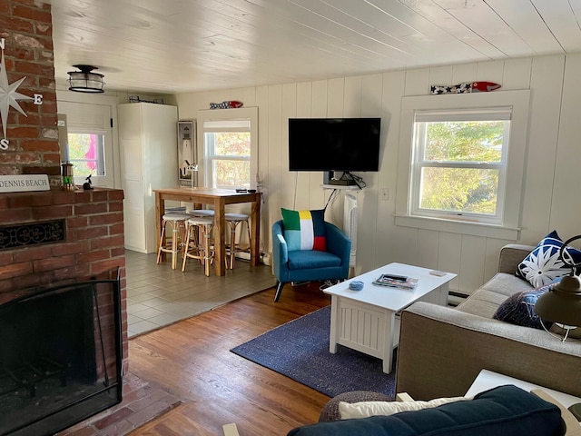 living area featuring plenty of natural light, wood finished floors, and wood ceiling