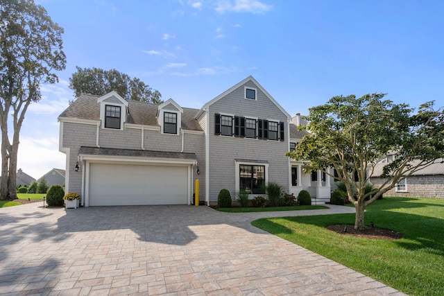 view of front of property featuring a garage and a front yard