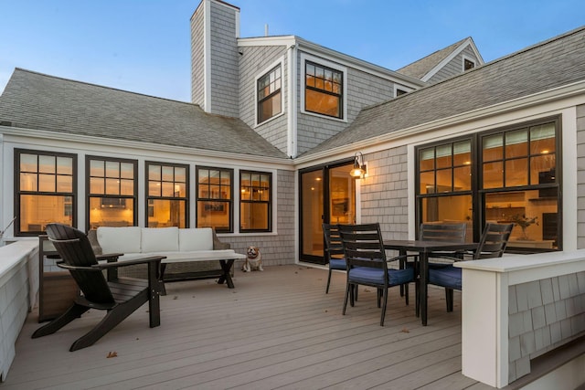 wooden deck with an outdoor living space