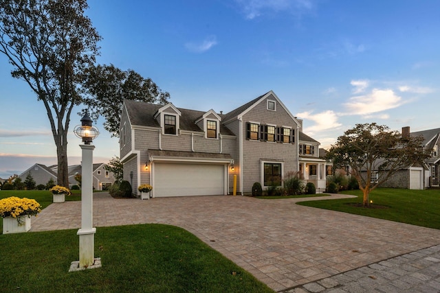 view of front of home featuring a garage and a yard