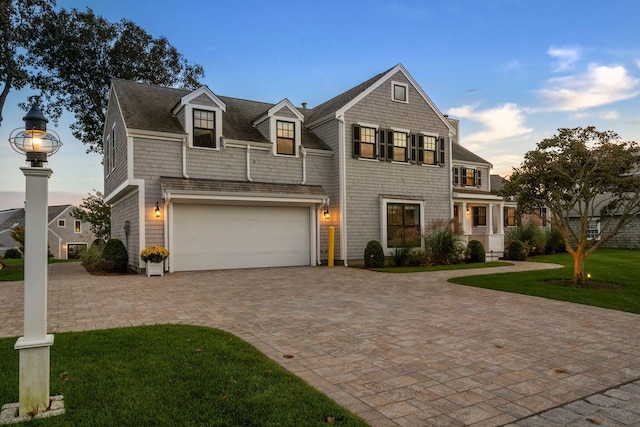 view of front of property featuring a yard and a garage