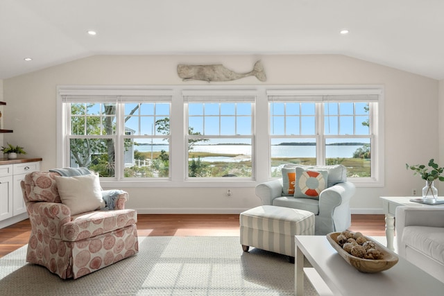 sunroom / solarium with a water view, plenty of natural light, and lofted ceiling