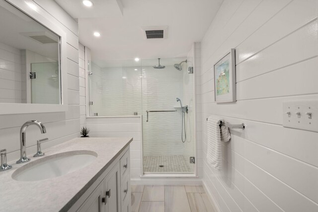 bathroom with an enclosed shower and vanity