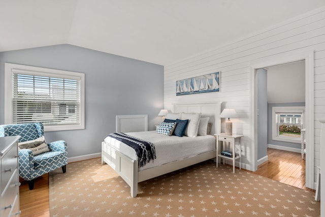 bedroom with vaulted ceiling and light hardwood / wood-style floors