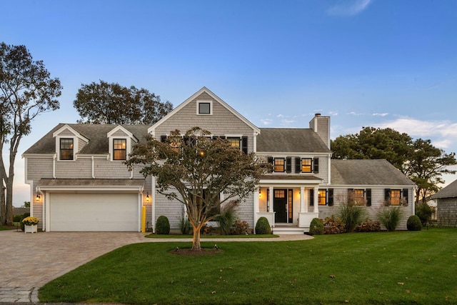 view of front facade with a garage and a front lawn