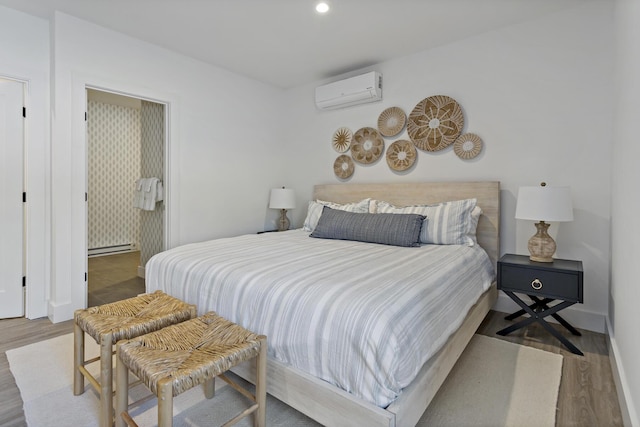 bedroom featuring a baseboard radiator, light wood-type flooring, and an AC wall unit