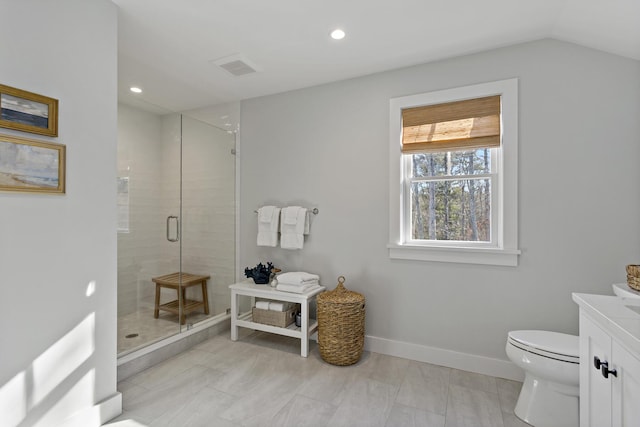 bathroom with a shower with door, vanity, vaulted ceiling, and toilet