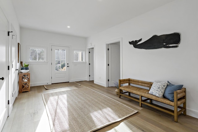 entryway with recessed lighting, light wood-style flooring, and baseboards