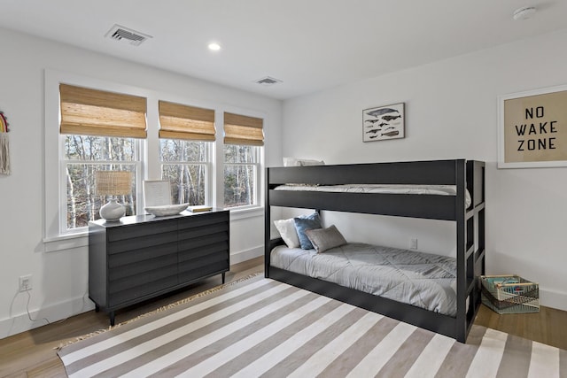 bedroom featuring recessed lighting, wood finished floors, visible vents, and baseboards