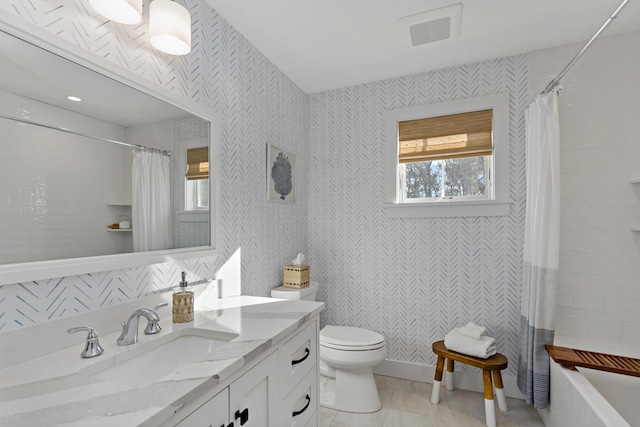 full bathroom featuring a wealth of natural light, visible vents, toilet, and vanity