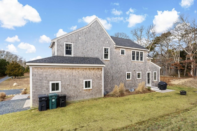 rear view of house with a yard