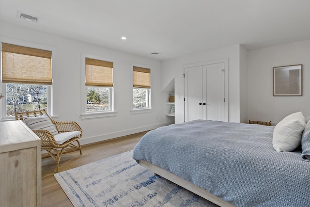 bedroom with recessed lighting, visible vents, baseboards, and light wood-style floors