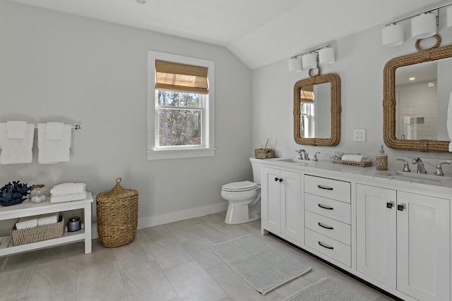 bathroom featuring vanity, vaulted ceiling, and toilet