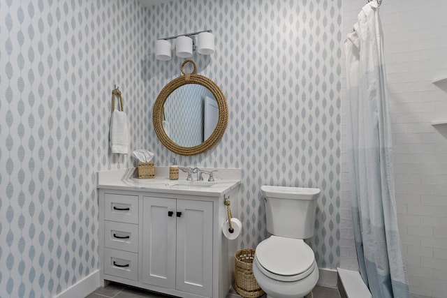 bathroom featuring vanity, tiled shower, wallpapered walls, tile patterned floors, and toilet