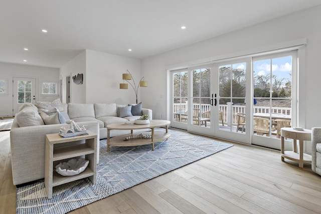 living area featuring recessed lighting, french doors, and wood finished floors