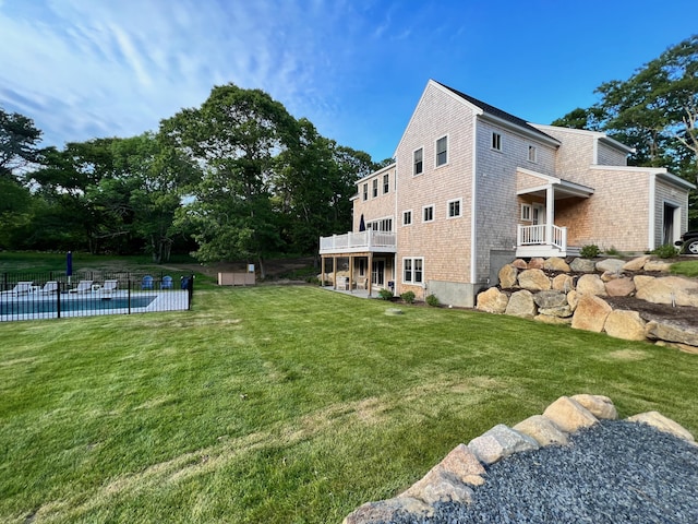 view of yard featuring a pool, a balcony, and a patio area