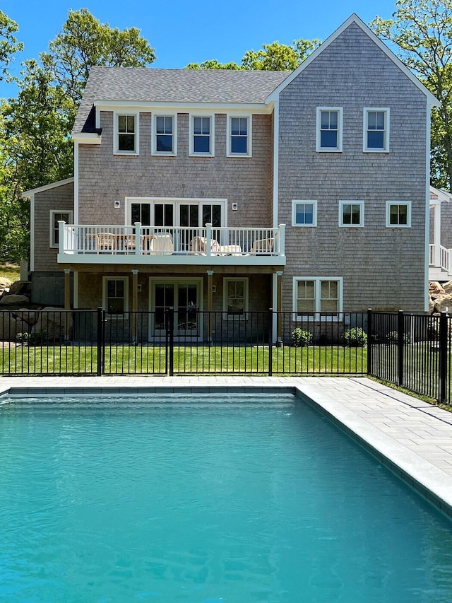 view of swimming pool with a yard, a fenced in pool, a wooden deck, and fence