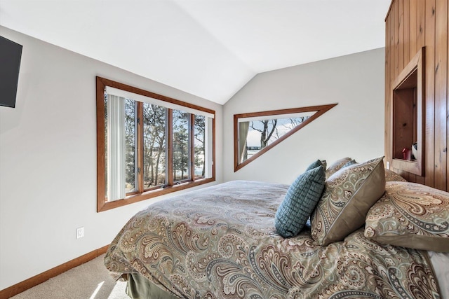 bedroom with carpet floors and lofted ceiling