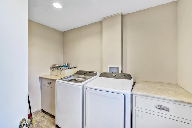 clothes washing area with independent washer and dryer and cabinets