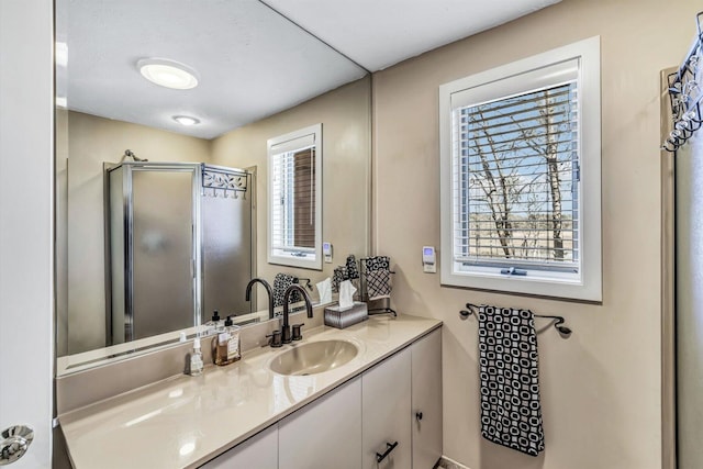 bathroom featuring walk in shower and vanity