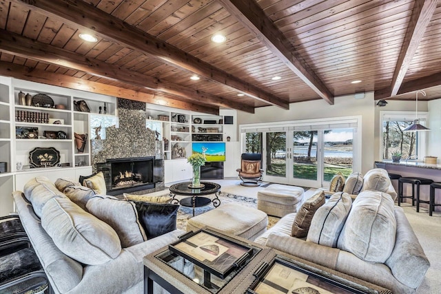 living room with wood ceiling, built in shelves, french doors, a premium fireplace, and beam ceiling