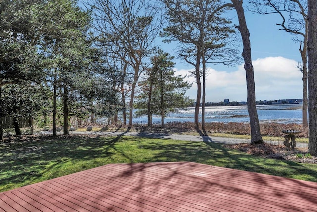 deck featuring a water view and a lawn