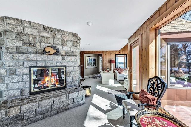 interior space with a brick fireplace and wood walls