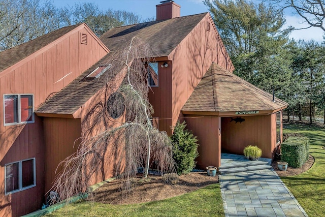 view of side of home featuring a lawn