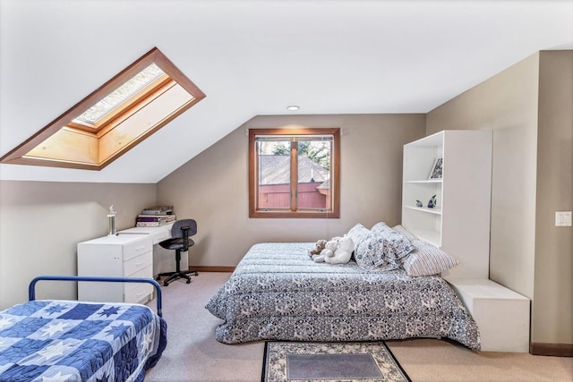 carpeted bedroom with lofted ceiling with skylight