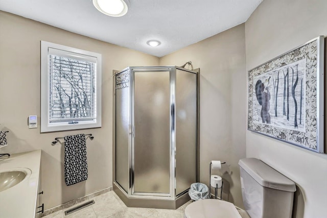 bathroom featuring toilet, a textured ceiling, walk in shower, tile patterned floors, and vanity