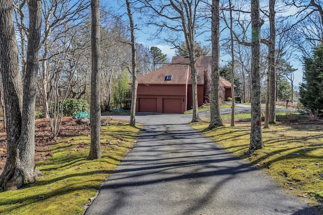 view of front of house featuring a garage and a front lawn