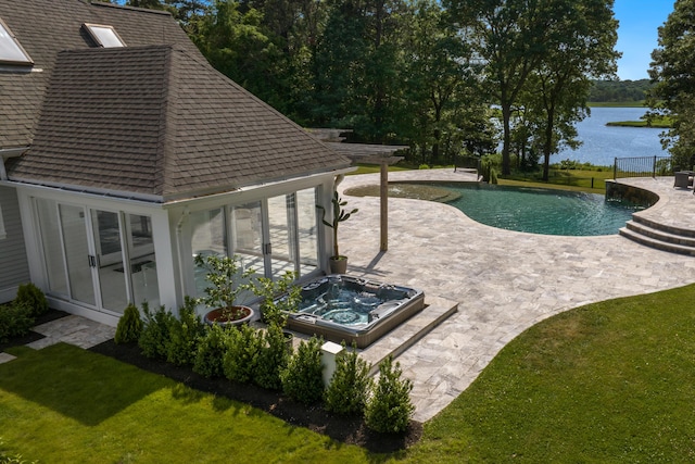 view of swimming pool with a lawn, an in ground hot tub, a patio area, and a water view