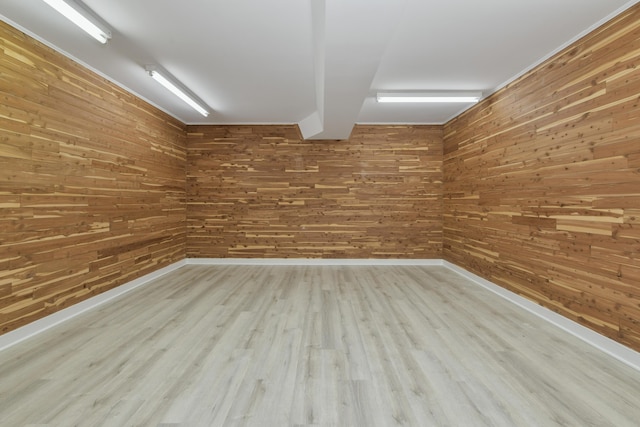 interior space featuring wooden walls and light hardwood / wood-style floors