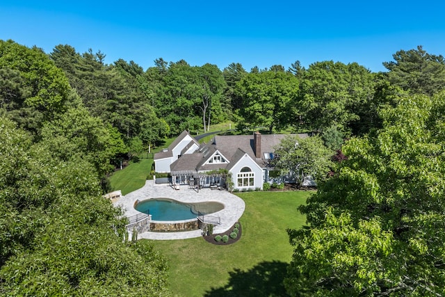 38 Beach Plum Hill Rd, Osterville, MA 02655 - back of house featuring a lawn, a forest view, a patio area, and an outdoor pool