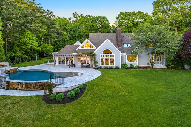 38 Beach Plum Hill Rd, Osterville, MA 02655 - rear view of property with a lawn, a patio, a chimney, and an outdoor pool