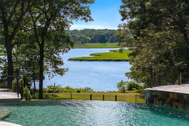 view of pool featuring a water view