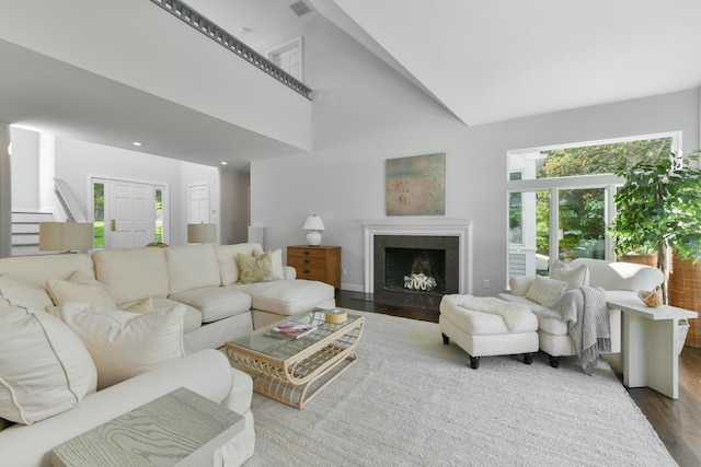 living room featuring a high ceiling and hardwood / wood-style floors