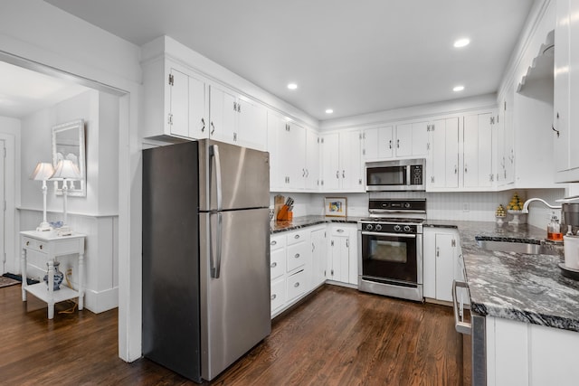 193 Main St, Sandwich, MA 02563 - kitchen featuring dark wood-type flooring, appliances with stainless steel finishes, a sink, and white cabinetry