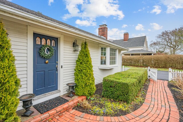193 Main St, Sandwich, MA 02563 - property entrance with fence, a gate, and a chimney